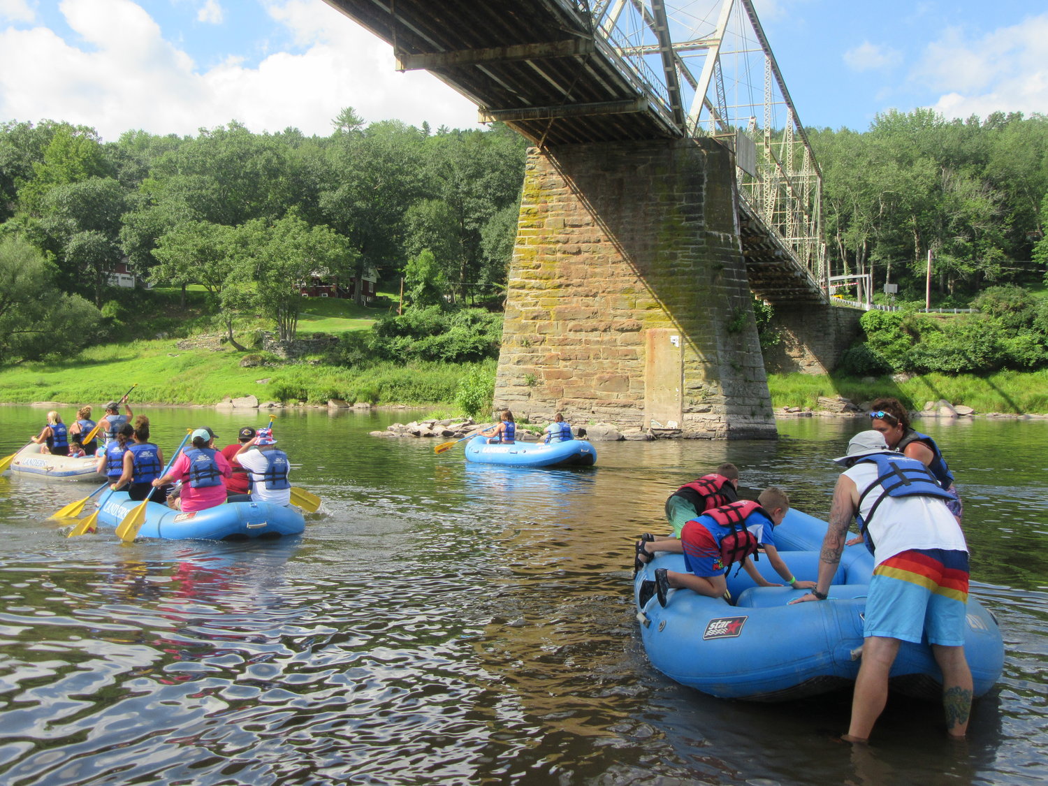 Participants in the Upper Delaware Council’s 34th annual family raft trip launch beneath the Skinners Falls-Milanville Bridge for their August 7 paddle to Lander’s Narrowsburg base.